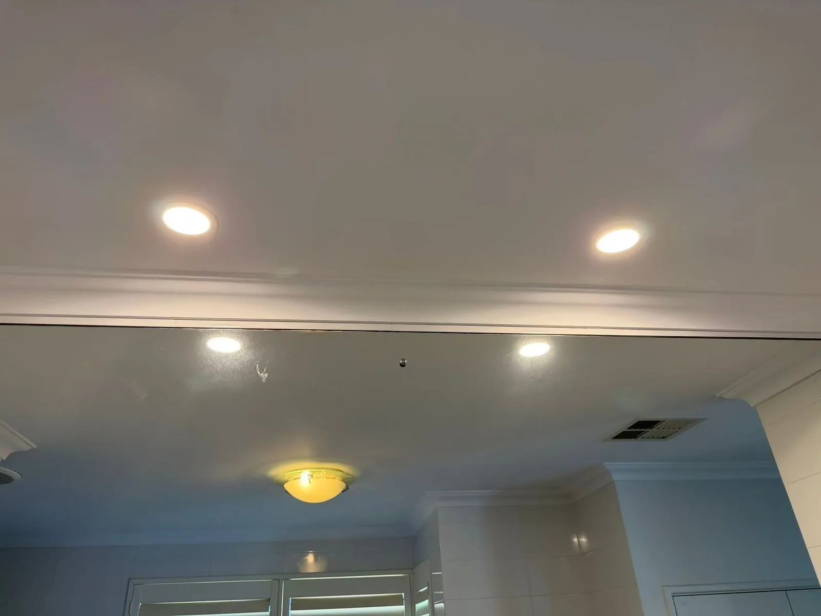 Finished recessed ceiling light above an interior window
